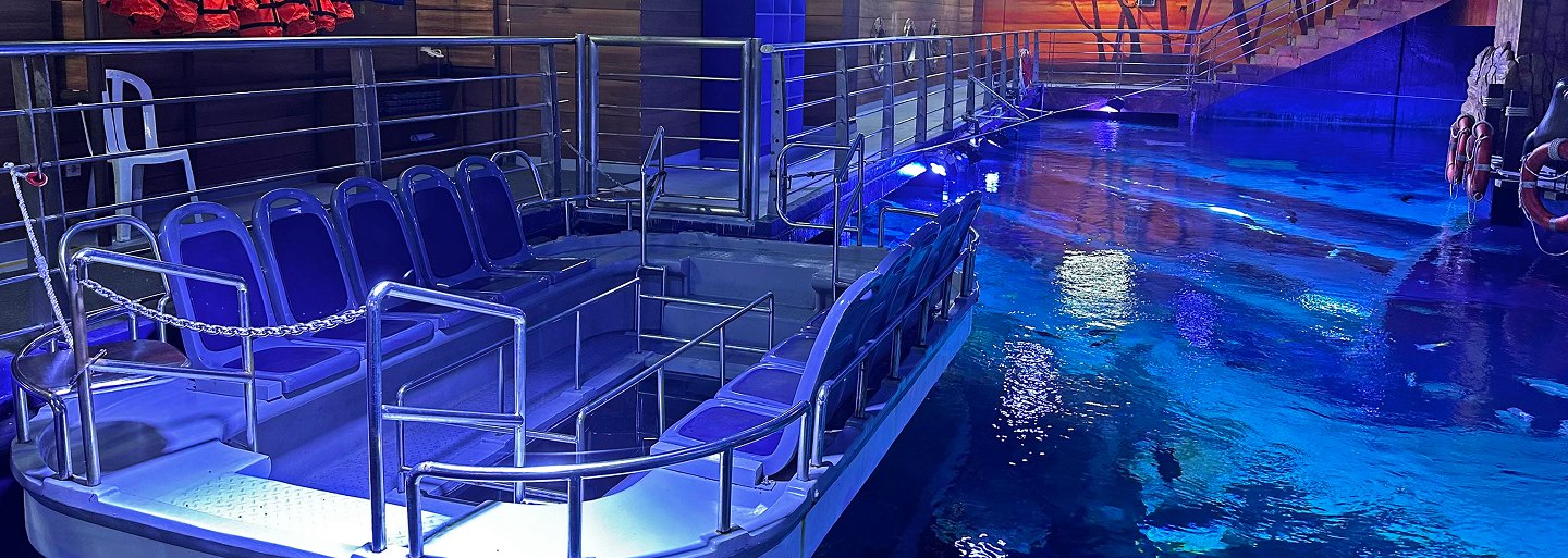 Elevated viewing platform over a blue marine tank at BX Sea Aquarium, Jakarta